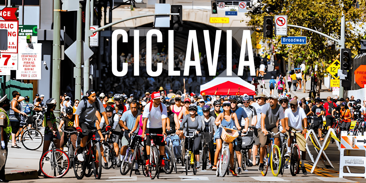 Crowd of cyclists participating in CicLAvia event on a busy urban street