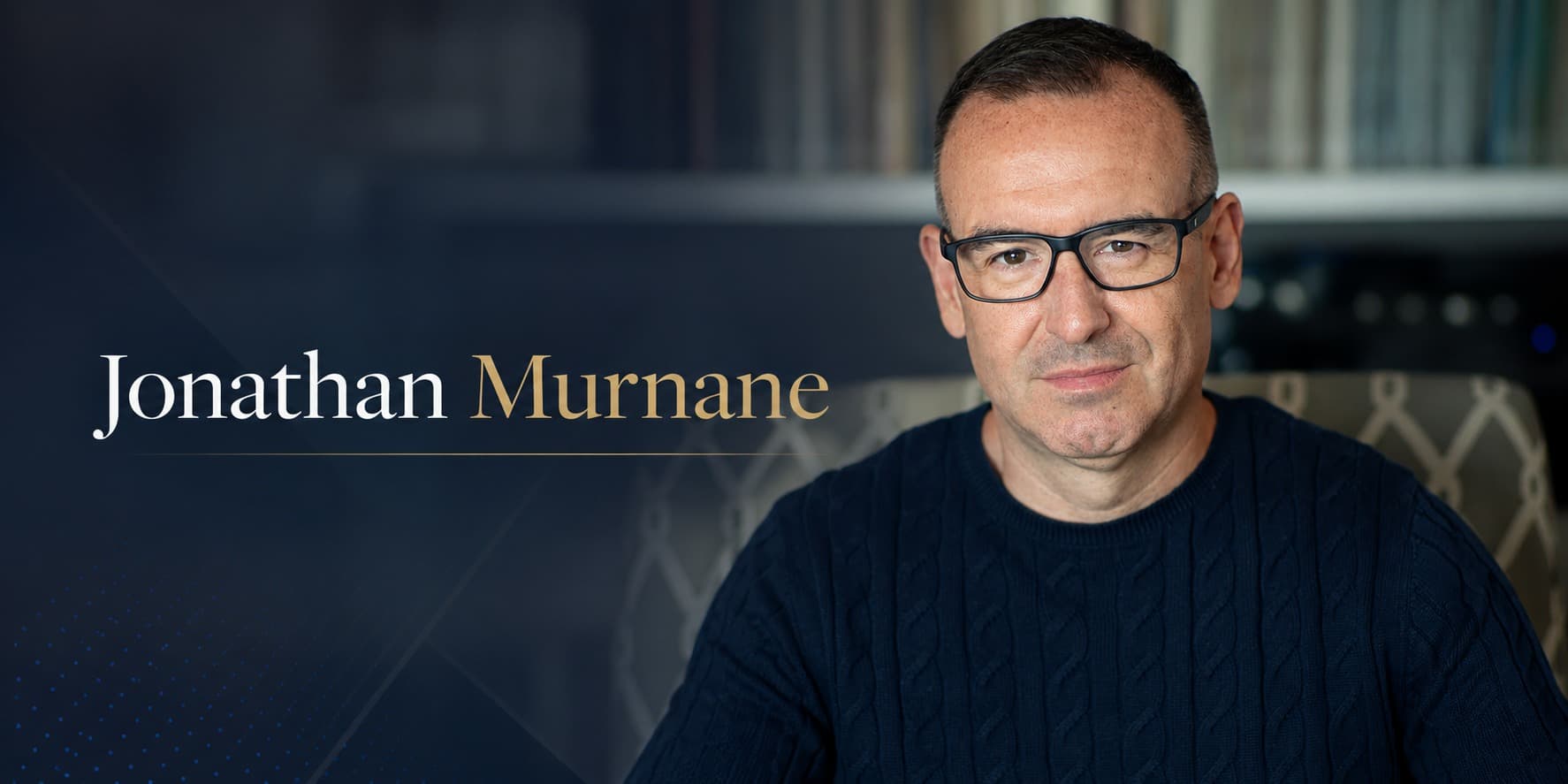 Jonathan Murnane portrait with name overlay in a dark library setting.