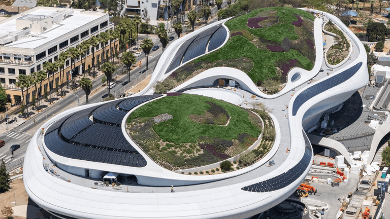 Aerial view of the Lucas Museum of Narrative Art with landscaped rooftop and solar panels in Los Angeles.