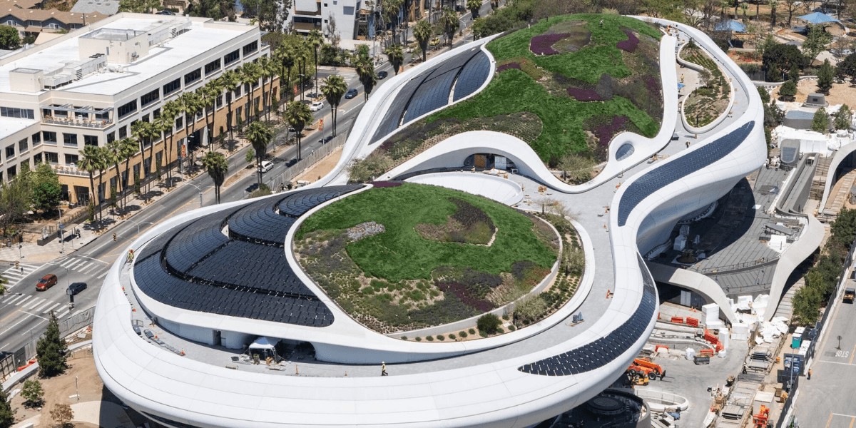 Aerial view of the Lucas Museum of Narrative Art with landscaped rooftop and solar panels in Los Angeles.