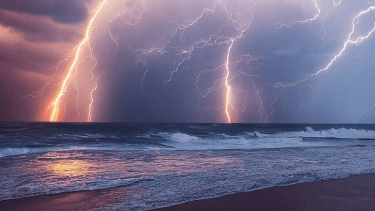Dramatic lightning bolts illuminate dark stormy skies over turbulent ocean waves at dusk