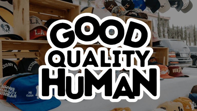 Hats displayed on wooden shelves with bold text overlay reading "Good Quality Human"