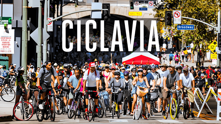 Crowd of cyclists participating in CicLAvia event on a busy urban street