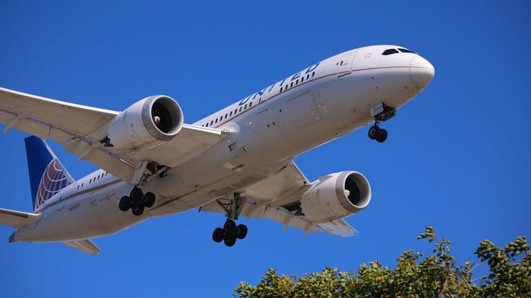 Free Photo Of A Large Airplane Flying Through The Sky With A Blue Sky