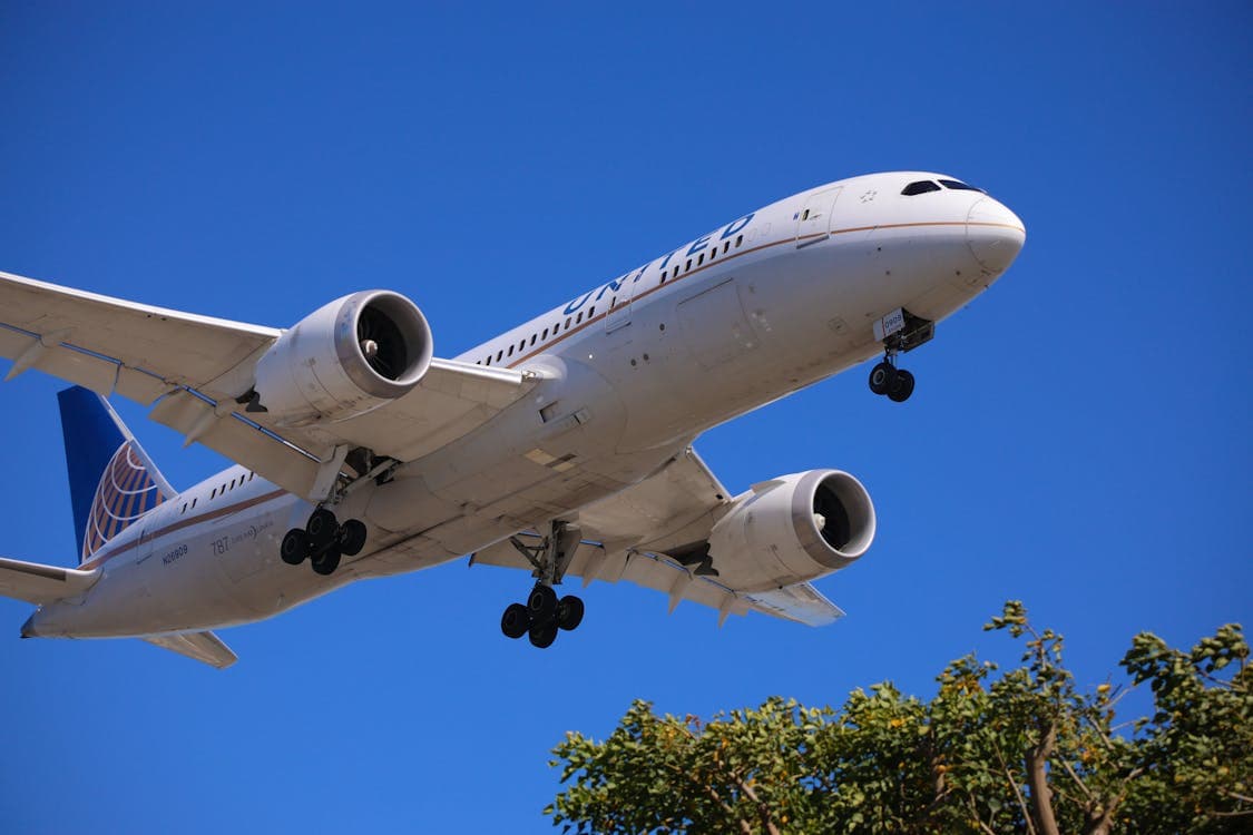 Free Photo Of A Large Airplane Flying Through The Sky With A Blue Sky