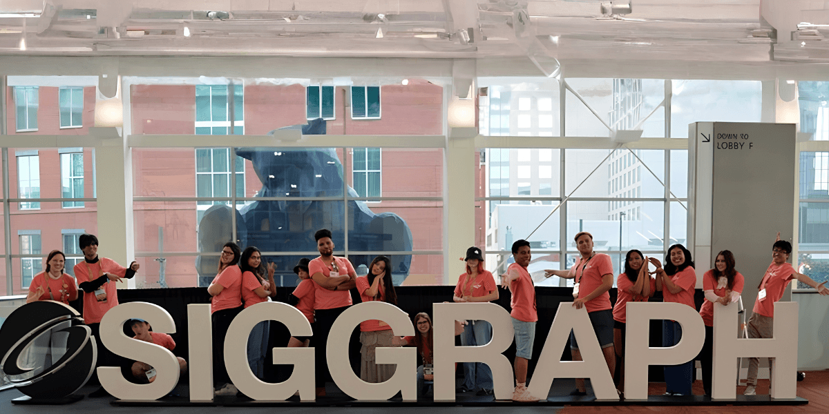 SIGGRAPH attendees posing behind large SIGGRAPH letters inside the Los Angeles Convention Center.