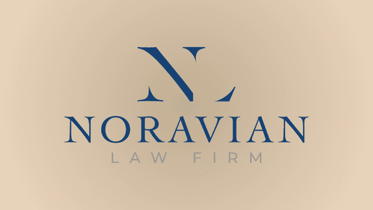 Attorney Carlo Noravian in professional office, providing personalized legal guidance for accident, injury, and insurance claims across California.