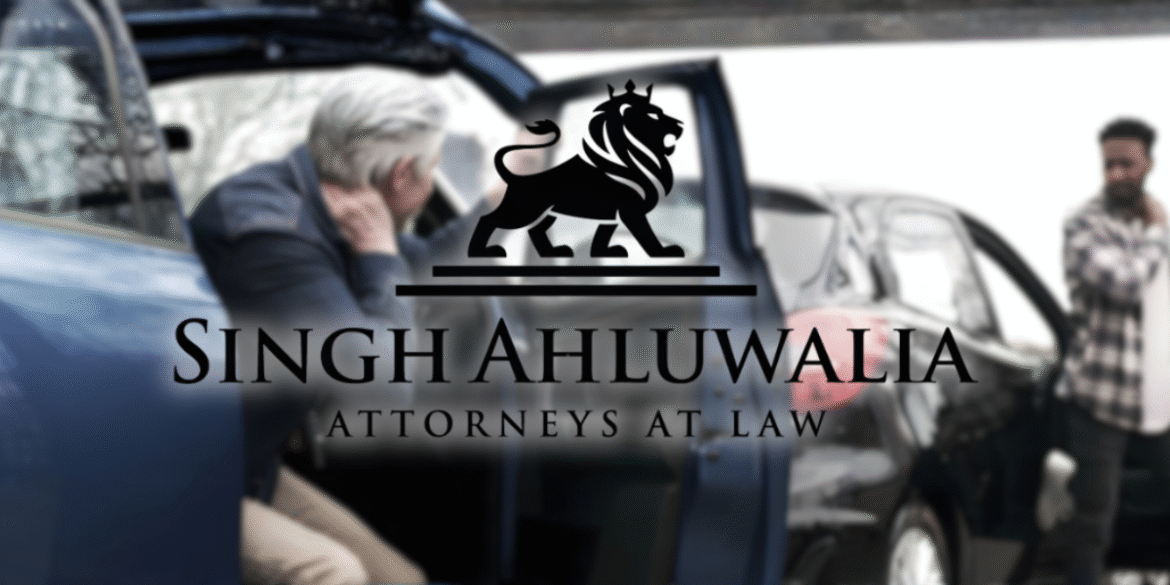 Car accident scene with injured person and lawyer's logo, Singh Ahluwalia Attorneys at Law, representing justice and recovery.
